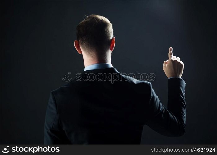 business, people, technology, choice and virtual reality concept - businessman in suit pointing finger to something invisible