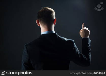 business, people, technology, choice and virtual reality concept - businessman in suit pointing finger to something invisible