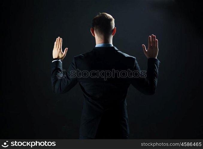 business, people, technology, cyberspace and office concept - businessman in suit working with invisible virtual reality screen