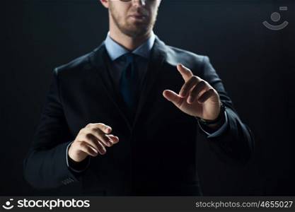 business, people, technology, cyberspace and office concept - close up of businessman in suit working with invisible virtual reality screen