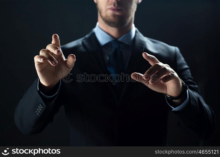 business, people, technology, cyberspace and office concept - close up of businessman in suit working with invisible virtual reality screen