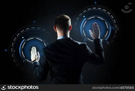 business, people, technology, cyberspace and virtual reality concept - businessman in suit working with projection over black background. businessman touching virtual screen