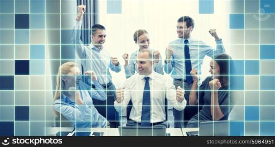business, people, technology, gesture and teamwork concept - smiling business team raising hands and celebrating victory in office over blue squared grid background