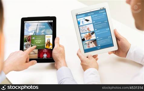 business, people, technology, internet and media concept - close up of businessman hands with news web page on tablet pc computer screens at office