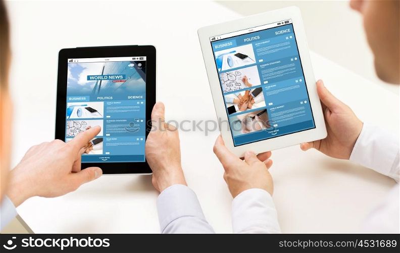business, people, technology, internet and media concept - close up of businessman hands with news web page on tablet pc computer screens at office