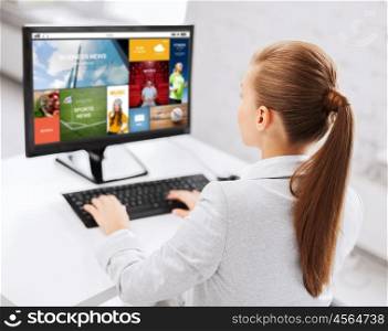 business, people, technology, media and education concept - businesswoman or student girl with internet page on computer screen sitting at office table