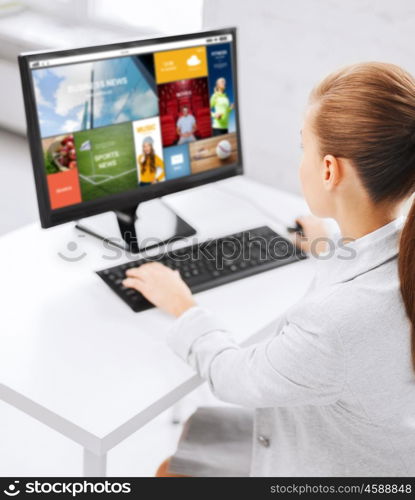 business, people, technology, media and education concept - businesswoman or student girl with internet page on computer screen sitting at office table