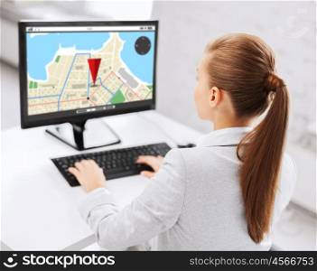 business, people, technology, navigation and education concept - businesswoman or student girl with gps navigator map on screen on computer screen sitting at office table