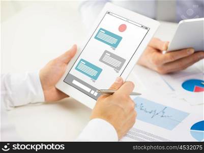 business, people, technology, online communication and teamwork concept - close up of businessman hands with messenger on tablet pc computer screen at office