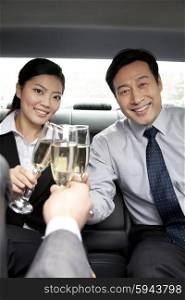 business people toasting in car