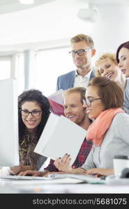 Business people using computer in creative office