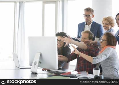 Business people using computer in office