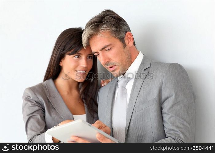 Business people using electronic tablet