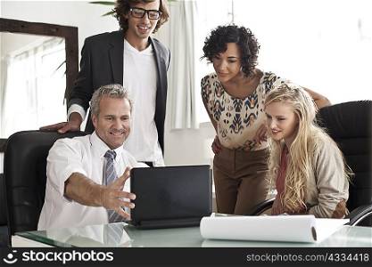 Business people using laptop at desk