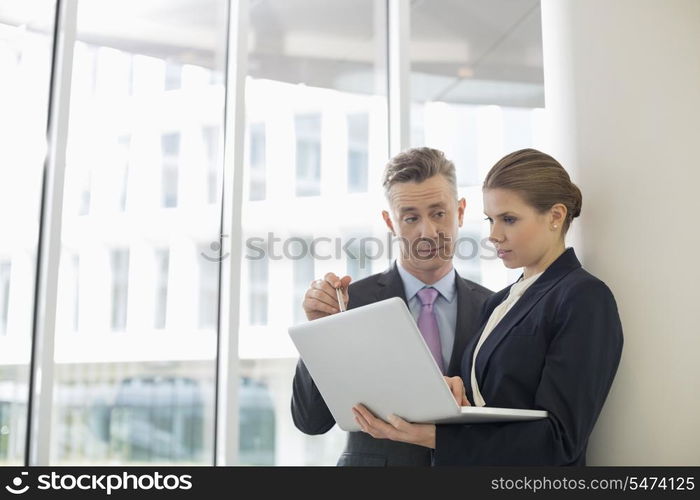 Business people using laptop in office