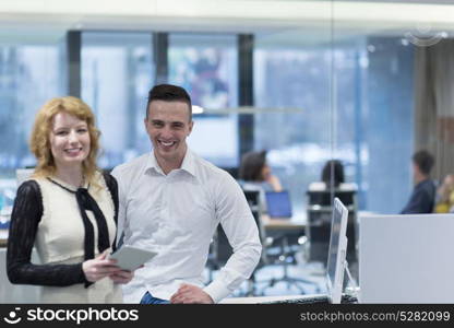 business people using tablet computer while preparing for next meeting colleagues in the background discussing ideas at startup office