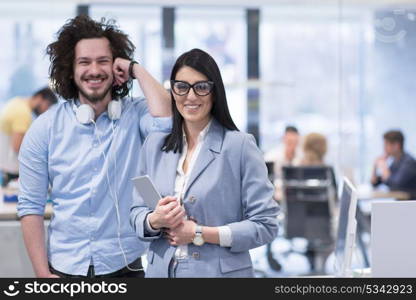 business people using tablet computer while preparing for next meeting colleagues in the background discussing ideas at startup office