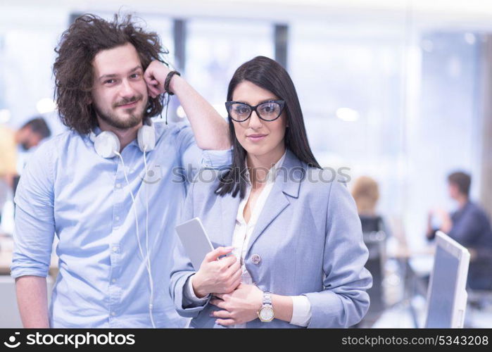 business people using tablet computer while preparing for next meeting colleagues in the background discussing ideas at startup office