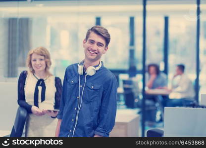 business people using tablet computer while preparing for next meeting colleagues in the background discussing ideas at startup office