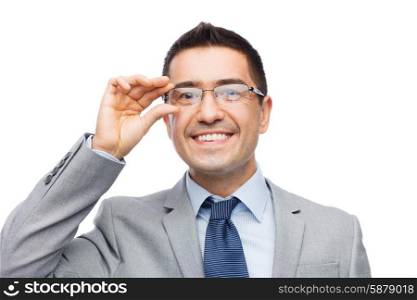 business, people, vision and office concept - happy smiling businessman in eyeglasses and suit