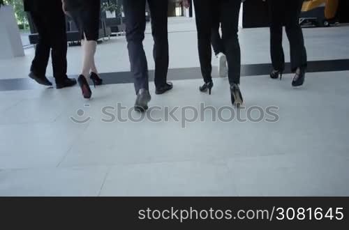 Business people walking in modern office building hall