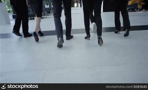 Business people walking in modern office building hall
