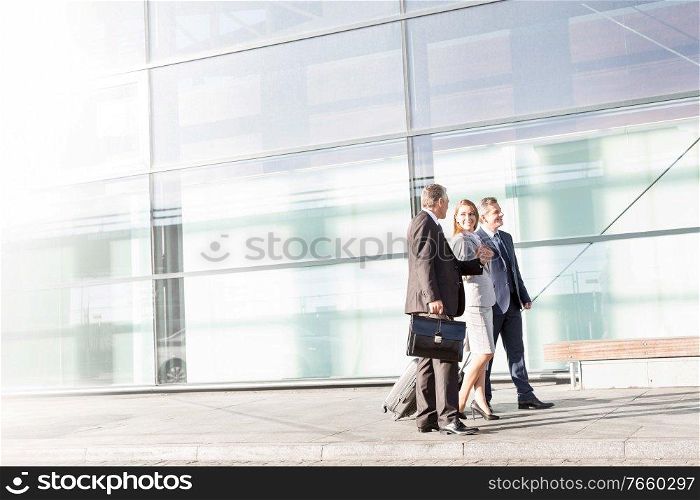 Business people walking while talking in airport