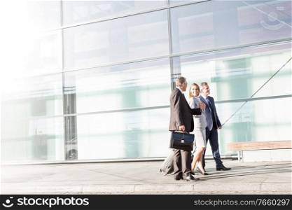 Business people walking while talking in airport