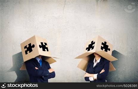 Business people wearing boxes. Unrecognizable business people wearing carton boxes on head