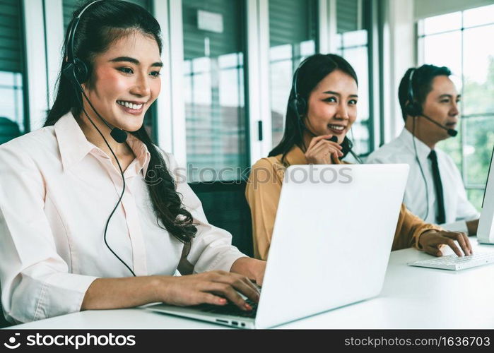 Business people wearing headset working actively in office . Call center, telemarketing, customer support agent provide service on telephone video conference call.. Business people wearing headset working actively in office