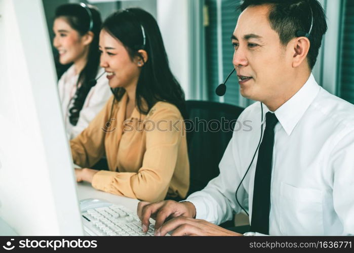 Business people wearing headset working actively in office . Call center, telemarketing, customer support agent provide service on telephone video conference call.. Business people wearing headset working actively in office