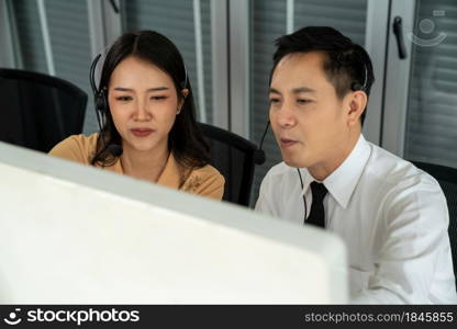 Business people wearing headset working actively in office . Call center, telemarketing, customer support agent provide service on telephone video conference call.. Business people wearing headset working actively in office