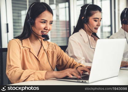 Business people wearing headset working actively in office . Call center, telemarketing, customer support agent provide service on telephone video conference call.. Business people wearing headset working actively in office