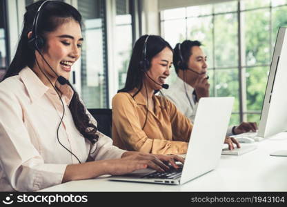 Business people wearing headset working actively in office . Call center, telemarketing, customer support agent provide service on telephone video conference call.. Business people wearing headset working actively in office