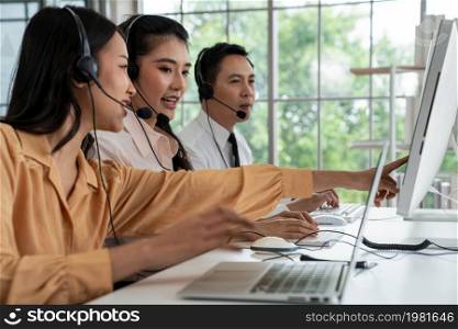 Business people wearing headset working actively in office . Call center, telemarketing, customer support agent provide service on telephone video conference call.. Business people wearing headset working actively in office