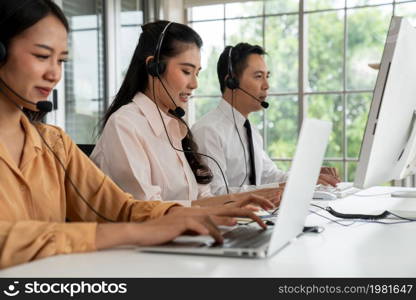 Business people wearing headset working actively in office . Call center, telemarketing, customer support agent provide service on telephone video conference call.. Business people wearing headset working actively in office