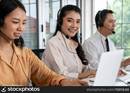 Business people wearing headset working actively in office . Call center, telemarketing, customer support agent provide service on telephone video conference call.. Business people wearing headset working actively in office