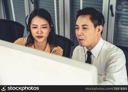 Business people wearing headset working actively in office . Call center, telemarketing, customer support agent provide service on telephone video conference call.. Business people wearing headset working actively in office