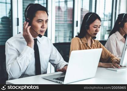 Business people wearing headset working actively in office . Call center, telemarketing, customer support agent provide service on telephone video conference call.. Business people wearing headset working actively in office