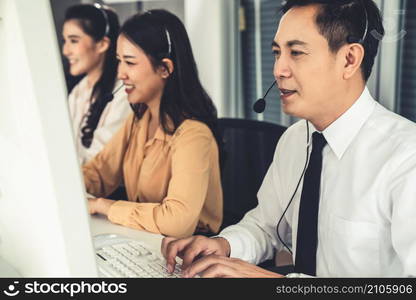 Business people wearing headset working actively in office . Call center, telemarketing, customer support agent provide service on telephone video conference call.. Business people wearing headset working actively in office