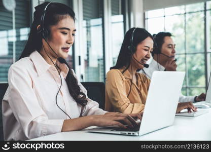 Business people wearing headset working actively in office . Call center, telemarketing, customer support agent provide service on telephone video conference call.. Business people wearing headset working actively in office