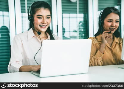 Business people wearing headset working actively in office . Call center, telemarketing, customer support agent provide service on telephone video conference call.. Business people wearing headset working actively in office