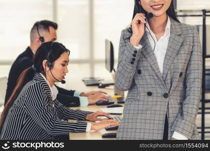 Business people wearing headset working in office to support remote customer or colleague. Call center, telemarketing, customer support agent provide service on telephone video conference call.