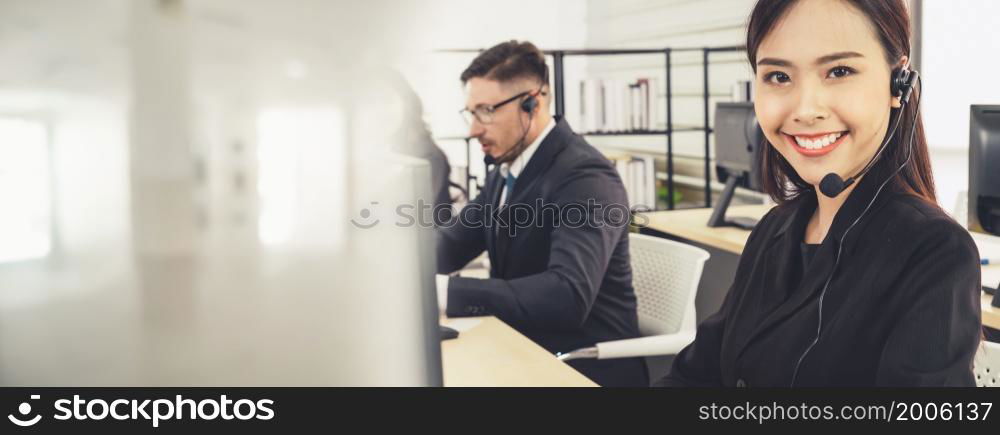 Business people wearing headset working in office to support remote customer or colleague. Call center, telemarketing, customer support agent provide service in broaden view .. Business people wearing headset working in office broaden view