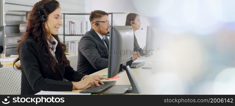 Business people wearing headset working in office to support remote customer or colleague. Call center, telemarketing, customer support agent provide service in broaden view .. Business people wearing headset working in office broaden view