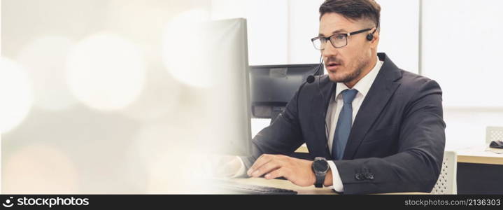 Business people wearing headset working in office to support remote customer or colleague. Call center, telemarketing, customer support agent provide service in broaden view .. Business people wearing headset working in office broaden view