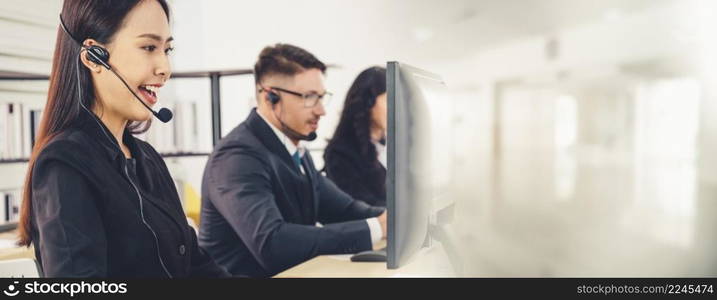 Business people wearing headset working in office to support remote customer or colleague. Call center, telemarketing, customer support agent provide service in broaden view .. Business people wearing headset working in office broaden view