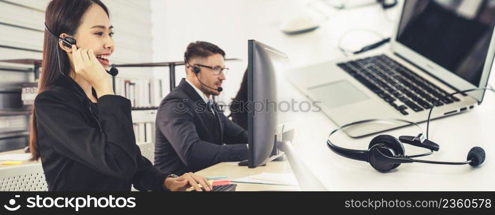 Business people wearing headset working in office to support remote customer or colleague. Call center, telemarketing, customer support agent provide service in broaden view .. Business people wearing headset working in office broaden view