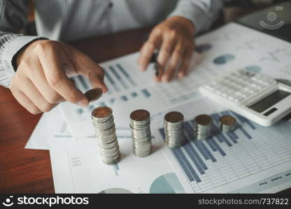 business people with coin stack and data spreadsheets, Investment concept.