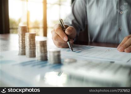 business people with coin stack and data spreadsheets, Investment concept.